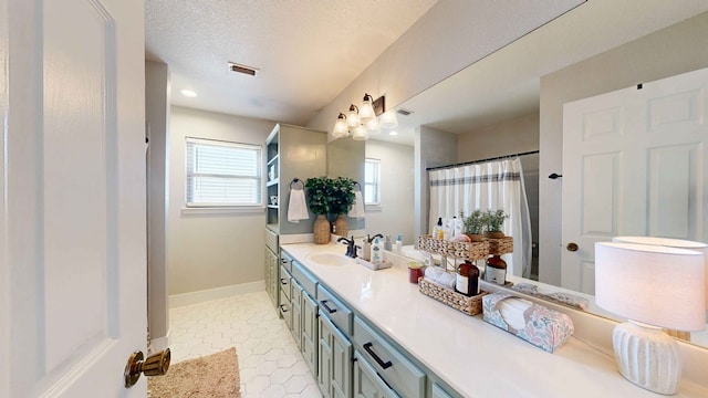 bathroom with vanity and a textured ceiling