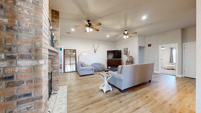 living room featuring light hardwood / wood-style floors and ceiling fan