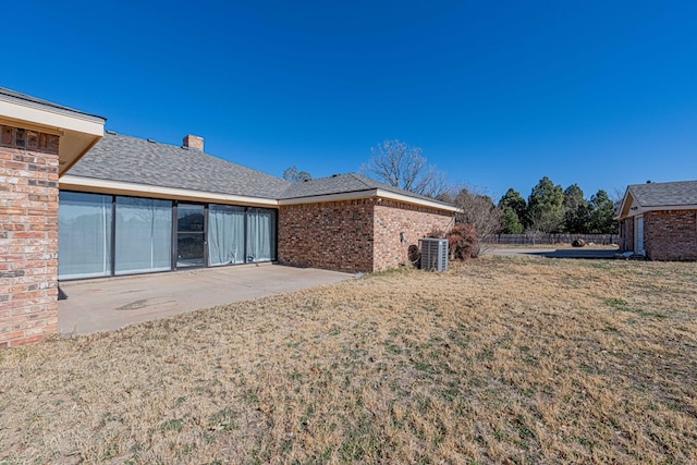 back of house featuring a patio, central AC, and a lawn