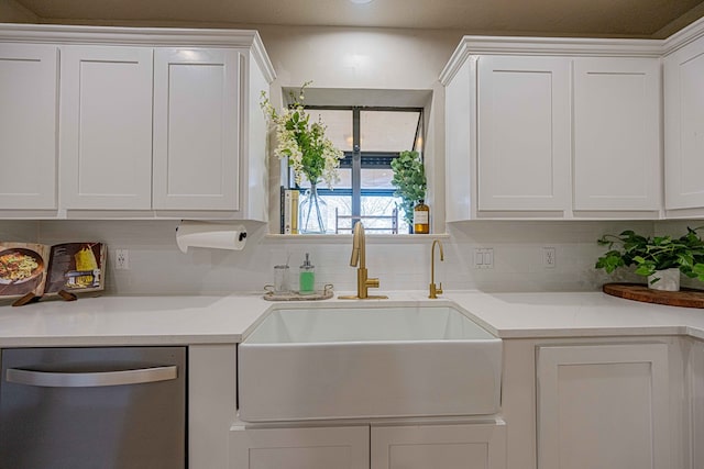 kitchen featuring dishwasher, sink, and white cabinets