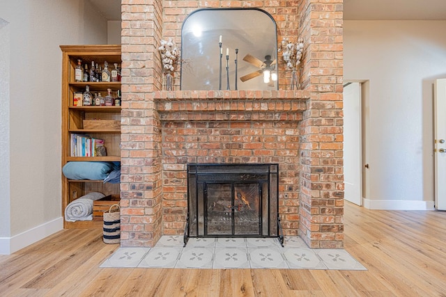 details with hardwood / wood-style floors, a brick fireplace, and ceiling fan