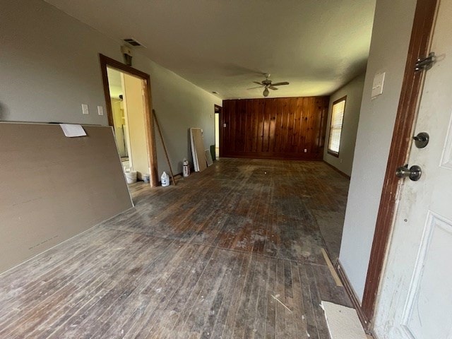 unfurnished room with hardwood / wood-style floors, a ceiling fan, and visible vents