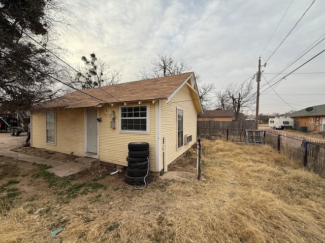 view of outbuilding featuring fence