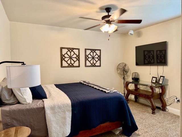 1406 Wrangler Ln, Midland, TX 79705 - carpeted bedroom featuring baseboards and a ceiling fan