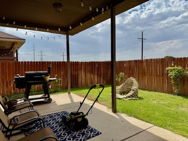 1406 Wrangler Ln, Midland, TX 79705 - fenced backyard featuring grilling area and a patio