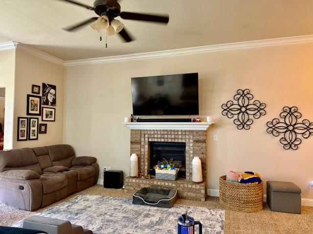 1406 Wrangler Ln, Midland, TX 79705 - carpeted living area with ceiling fan, ornamental molding, and a fireplace