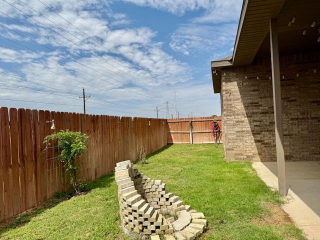 1406 Wrangler Ln, Midland, TX 79705 - fenced backyard with a patio area
