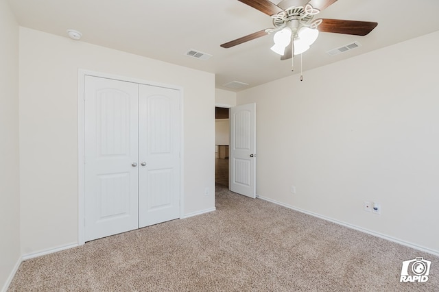 unfurnished bedroom featuring a closet, carpet, and visible vents