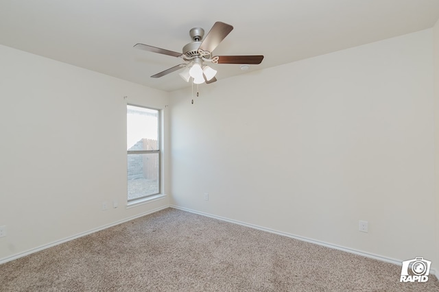 carpeted empty room featuring baseboards and a ceiling fan