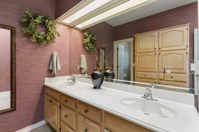 full bath featuring double vanity, a sink, and tile patterned floors