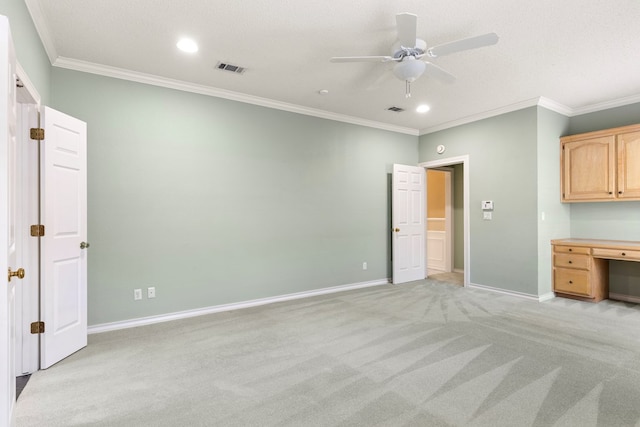 unfurnished bedroom featuring baseboards, visible vents, ornamental molding, and light carpet