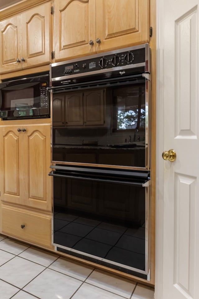 room details featuring black appliances and light brown cabinets