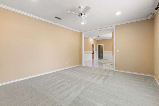 unfurnished room with recessed lighting, ceiling fan, visible vents, ornamental molding, and light colored carpet