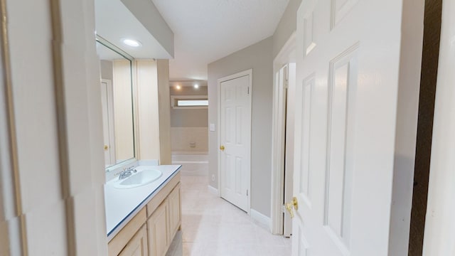 3608 Apollo Ct, Midland, TX 79707 - bathroom with vanity, tile patterned flooring, and a tub to relax in