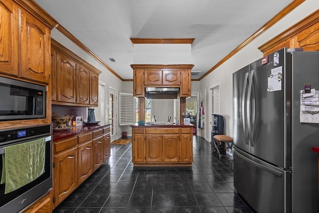 kitchen with crown molding, dark tile patterned floors, and appliances with stainless steel finishes