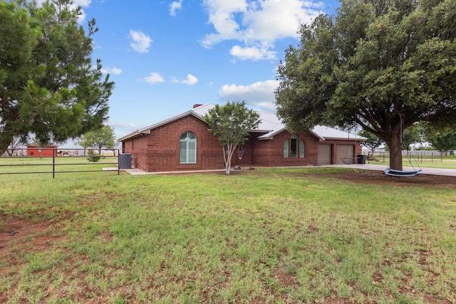 ranch-style home with a garage and a front lawn