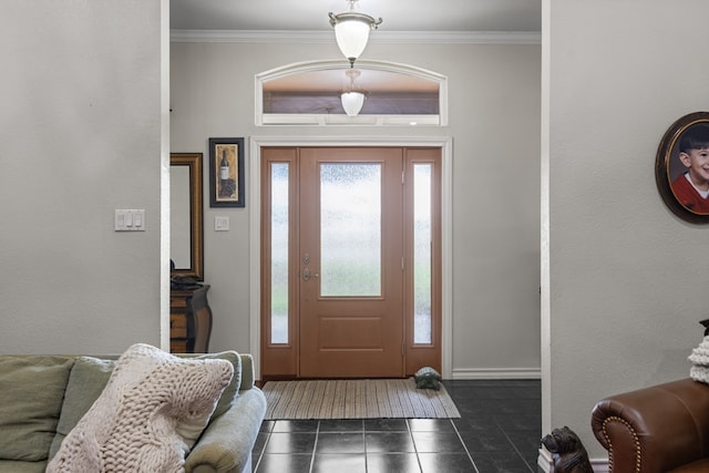 tiled entrance foyer featuring crown molding