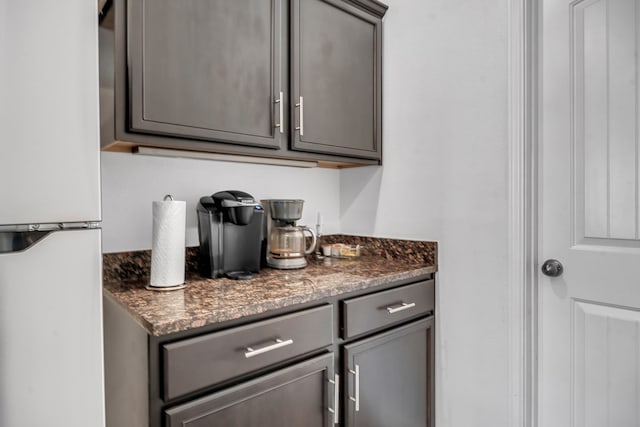 bar area with freestanding refrigerator