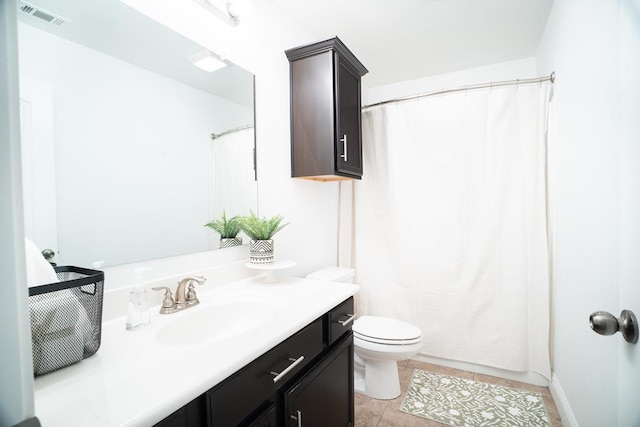 bathroom with vanity, toilet, tile patterned floors, and curtained shower