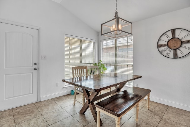 dining space featuring a chandelier, vaulted ceiling, light tile patterned floors, and baseboards
