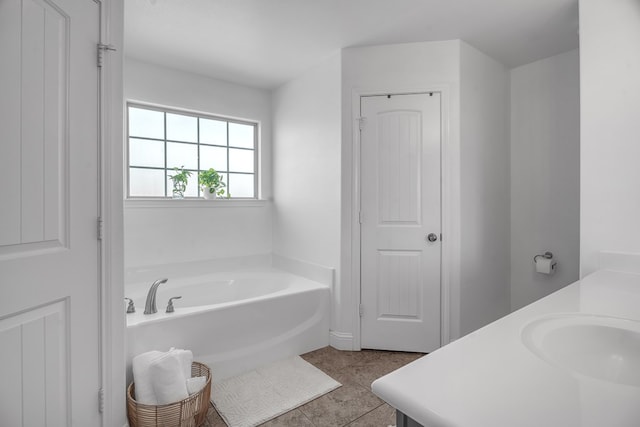 bathroom featuring a bath, tile patterned flooring, and vanity