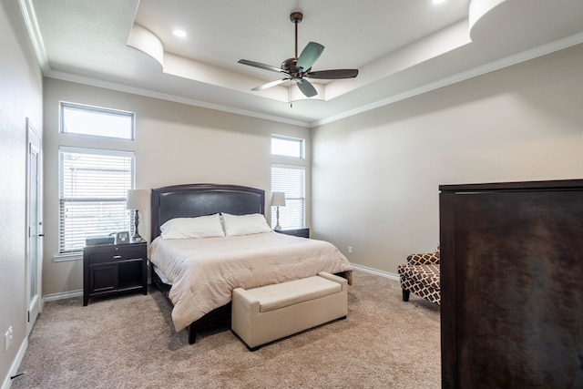 bedroom with light carpet, baseboards, a raised ceiling, and ornamental molding