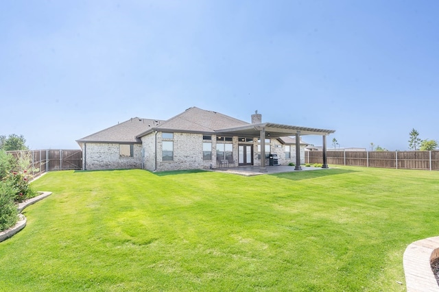 back of property featuring a patio area, a fenced backyard, a lawn, and a pergola