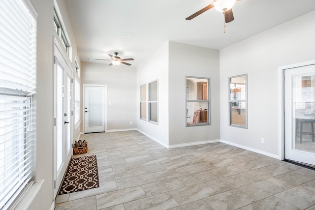 interior space with ceiling fan