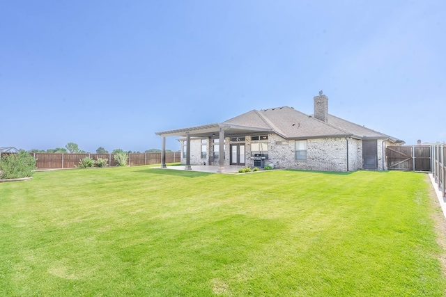 back of property with a fenced backyard, a patio, a lawn, and a pergola