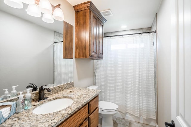 bathroom featuring toilet, vanity, visible vents, and tile patterned floors