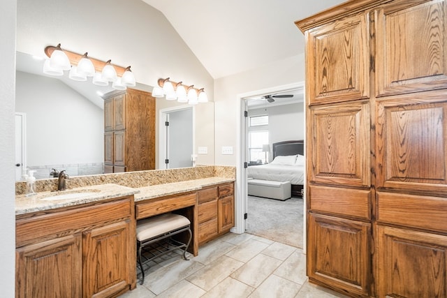 ensuite bathroom with ceiling fan, ensuite bath, vaulted ceiling, and vanity