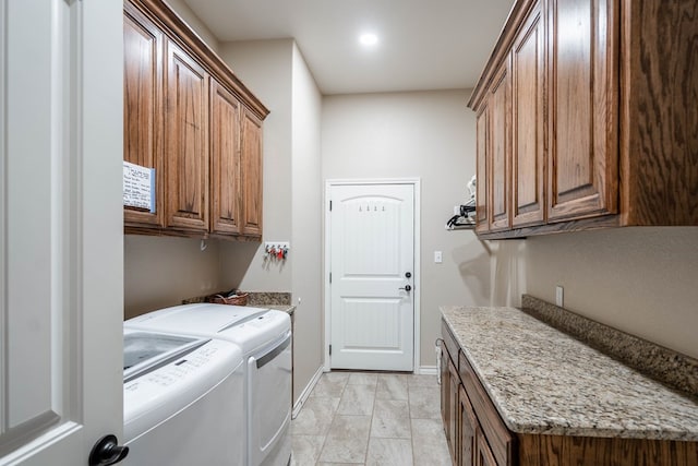 laundry room featuring washer and dryer, cabinet space, and baseboards