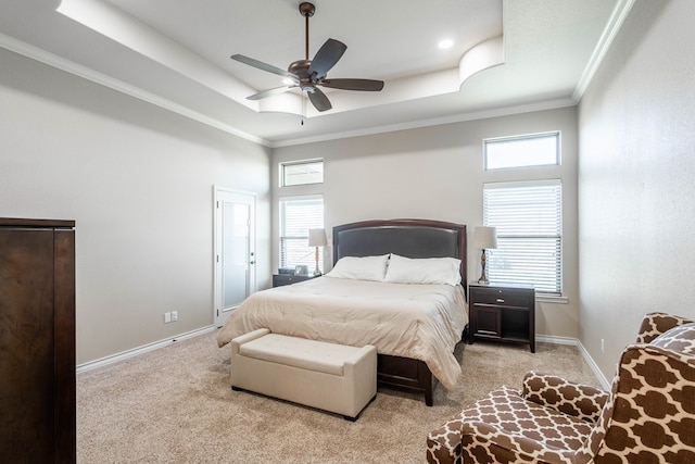 bedroom featuring light carpet, baseboards, and a raised ceiling