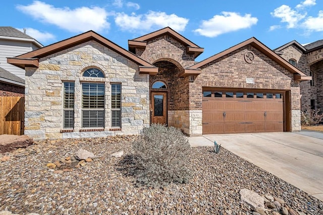 french country style house with driveway, an attached garage, fence, and brick siding