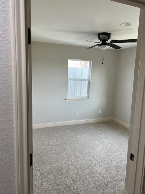 unfurnished room featuring carpet flooring and ceiling fan