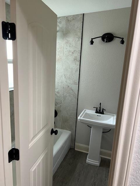 bathroom featuring hardwood / wood-style floors and tiled shower / bath