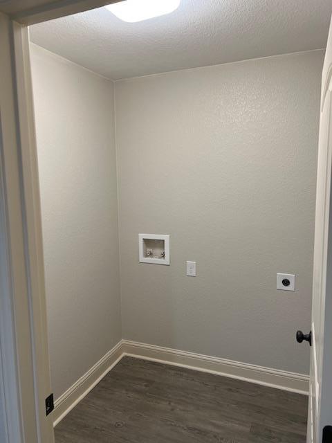 clothes washing area featuring electric dryer hookup, dark hardwood / wood-style flooring, and hookup for a washing machine