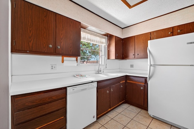 4709 Shadylane Dr, Midland, TX 79703 - kitchen featuring white appliances, a sink, light countertops, light tile patterned floors, and a textured ceiling