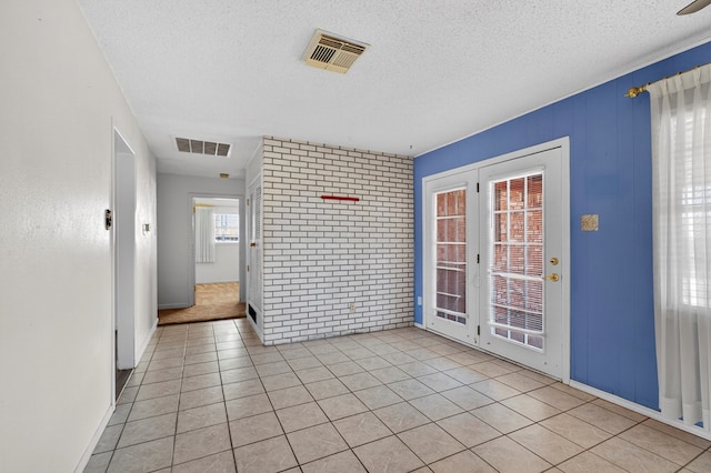 4709 Shadylane Dr, Midland, TX 79703 - empty room featuring light tile patterned flooring, a textured ceiling, and baseboards