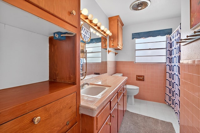 4709 Shadylane Dr, Midland, TX 79703 - full bath with tile walls, toilet, vanity, wainscoting, and tile patterned floors
