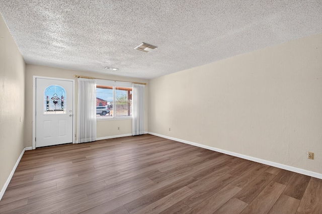 4709 Shadylane Dr, Midland, TX 79703 - entryway featuring wood finished floors, a textured ceiling, and baseboards
