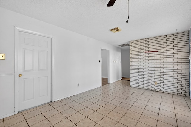 4709 Shadylane Dr, Midland, TX 79703 - spare room featuring a textured ceiling, a ceiling fan, and light tile patterned floors