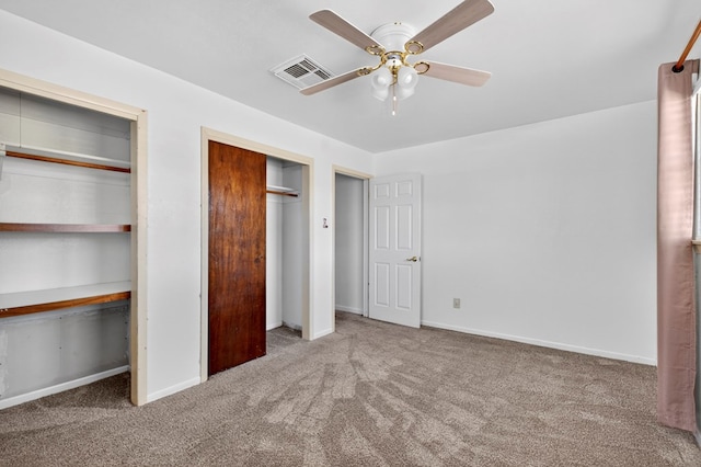 4709 Shadylane Dr, Midland, TX 79703 - unfurnished bedroom with carpet, multiple closets, baseboards, and a ceiling fan