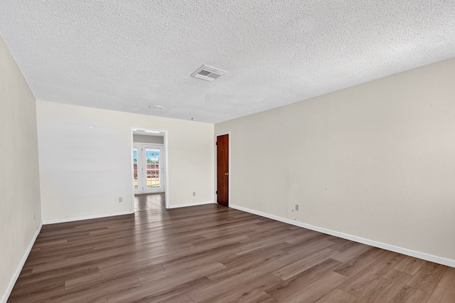 4709 Shadylane Dr, Midland, TX 79703 - empty room featuring wood finished floors, french doors, a textured ceiling, and baseboards