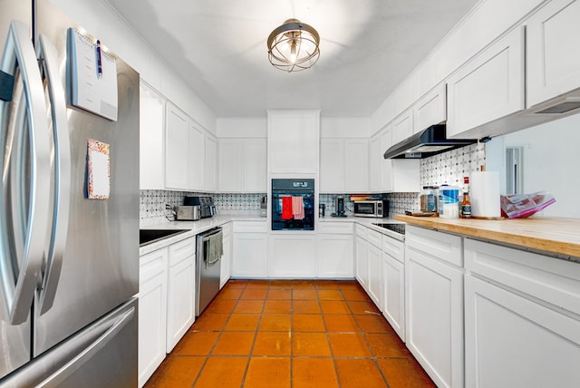 2817 W Shandon Ave, Midland, TX 79705 - kitchen with stainless steel appliances, decorative backsplash, exhaust hood, and white cabinetry