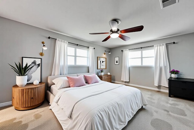 2817 W Shandon Ave, Midland, TX 79705 - carpeted bedroom with multiple windows, baseboards, and a ceiling fan