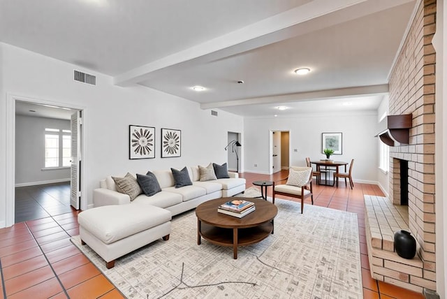 2817 W Shandon Ave, Midland, TX 79705 - living area featuring beam ceiling, baseboards, tile patterned flooring, and a brick fireplace