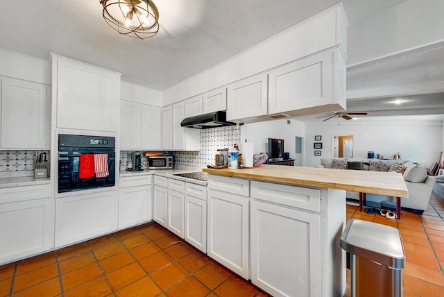 2817 W Shandon Ave, Midland, TX 79705 - kitchen featuring black oven, open floor plan, tasteful backsplash, and a peninsula