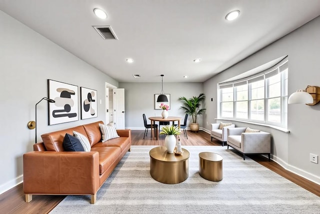 2817 W Shandon Ave, Midland, TX 79705 - living area featuring baseboards, wood finished floors, and recessed lighting