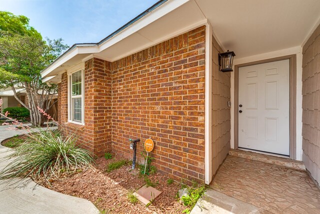 property entrance with brick siding